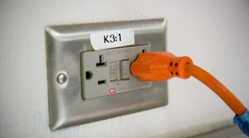 A grounded outlet has a reset switch in its center.