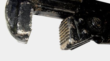The pipe wrench's jaws expand to a greater width than adjustable wrenches.