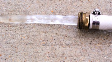 The garden hose conveniently helps remove mildew from the mailbox post.