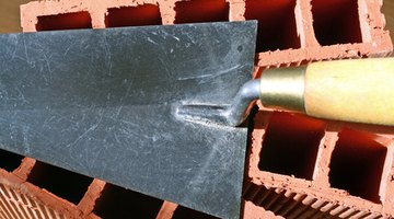 The flat side of a trowel can be used to level out the concrete surface.