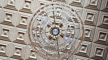 Tin tiles behind a chandelier.