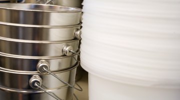 Place a bucket under the water hose at the back of the washer.