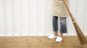 Use a broom to comb over the rug to collect the loose fibers