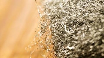 Use very fine steel wool to sand wood between stain layers.