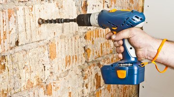 Drilling a hole into a brick wall