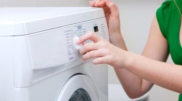 Woman setting front loading washing machine