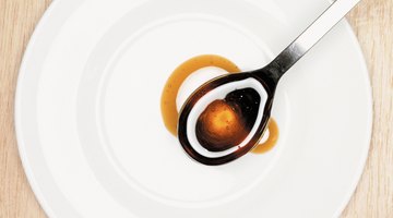 Amber color sorghum on a spoon.