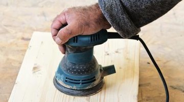 Man holding power sander