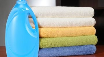 Laundry cleaning product next to pile of clean towels
