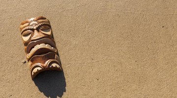 Tiki mask on sand.