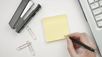man writing down notes