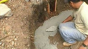 Mortar is spread into a trench for a curved bench.