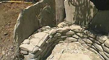Flagstone slabs should extend 2 feet above the base.