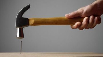 Use a hammer and roofing nails or a drill and screws.