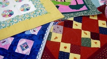 Choose a quilt or comforter for the bed.